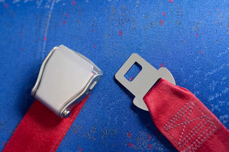 Unlocked seat belt lays on the chair.の写真素材