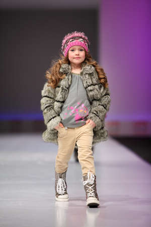 MOSCOW - FEBRUARY 22: Unidentified pretty child model wear fashions by Snowimage and walk the catwalk in the Collection Premiere Moscow, an international fashion fair for Eastern Europe, on February 22, 2011 in Moscow, Russia.のeditorial素材