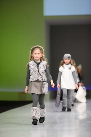 MOSCOW - FEBRUARY 22: Unidentified pretty child models wear fashions by Snowimage and walk the catwalk in the Collection Premiere Moscow, an international fashion fair for Eastern Europe, on February 22, 2011 in Moscow, Russia.のeditorial素材