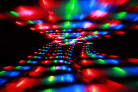 Abstract colorful spots on black background, bright pink, red, green and blue freezelight paint 