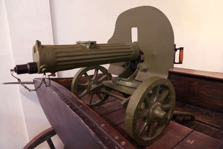 old Soviet green gun stands on wooden cart; weapons since World War II