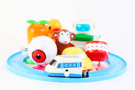 group of eight little bright clockwork toys on white background