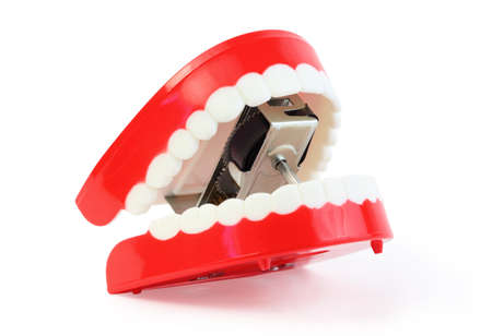 small toy jaw with white teeth swallowed mechanism on white background