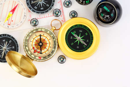 group of twelve different small and big compasses on white backgroundの写真素材