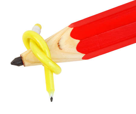 flexible yellow pencil and big wooden red pencil on white background, yellow pencil tied knot around big pencil; small pencil parasite on large pencilの写真素材