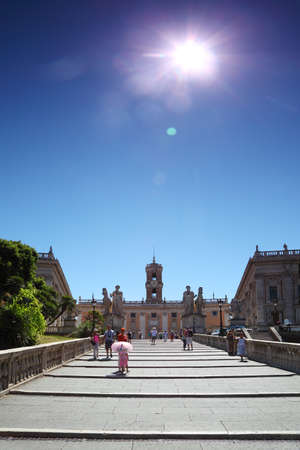 tourists go up stairs to Palazzo Senatorio at summer day in Rome, Italyのeditorial素材