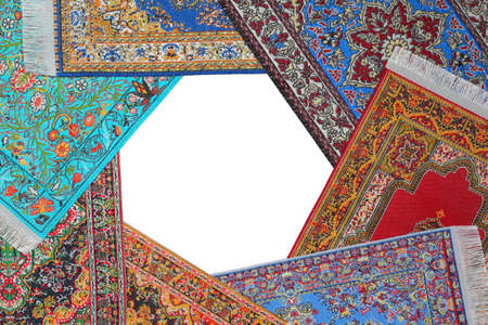 Seven bright carpets lie on circle on  white backgroundの写真素材