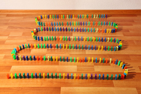 Curved series of multi-colored plastic parts of constructor on floor