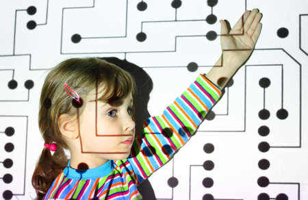 little girl in striped shirts shows on black circle on circuit, board, projector