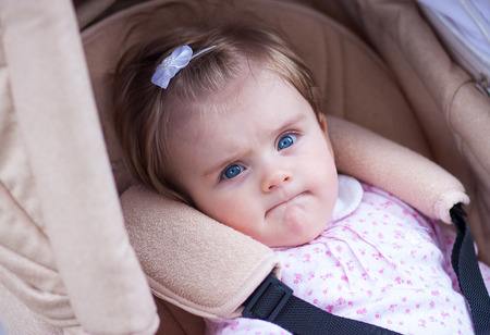 child is sitting in a carriage