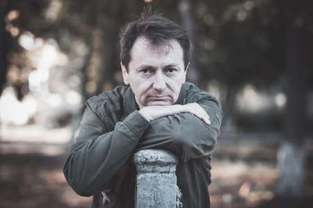 man in the jacket on a background of trees