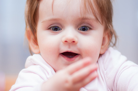 little baby on a blue background. positive emotionsの写真素材