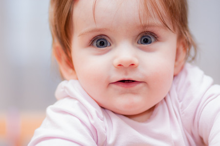 little baby on a blue background. positive emotionsの写真素材