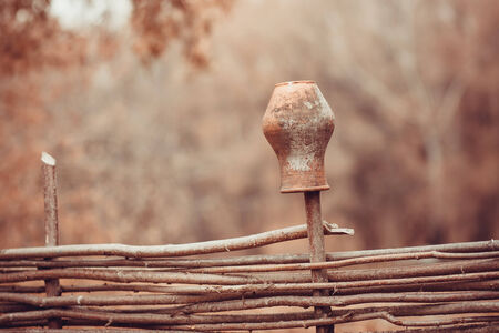 clay jug on a wicker fence. rural scenesの写真素材