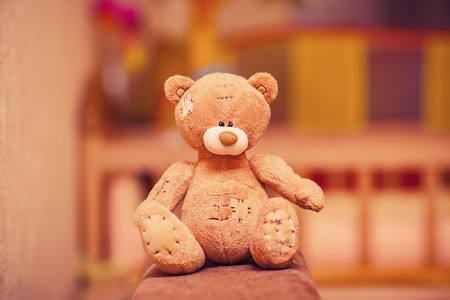 brown teddy bear sitting on the couch. toyの写真素材