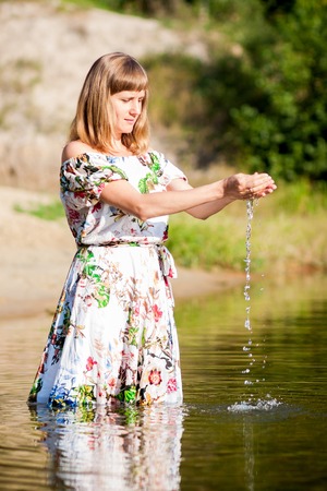 beautiful girl in dress on the river.