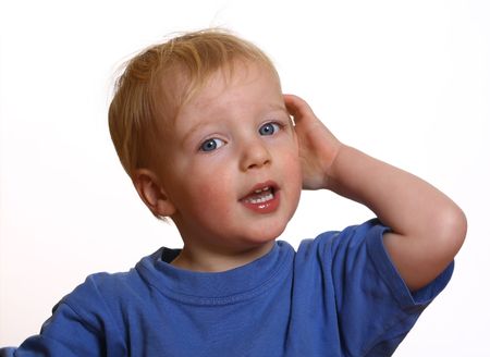 Surprised young boy with white backgroundの写真素材