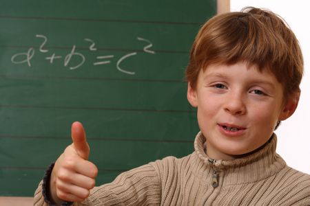 Happy schoolboy at the chalkboardの写真素材