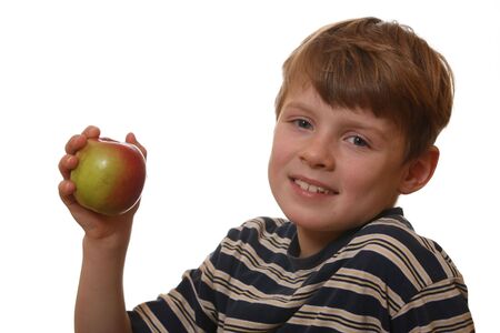 Happy and healthy boy shows an appleの写真素材