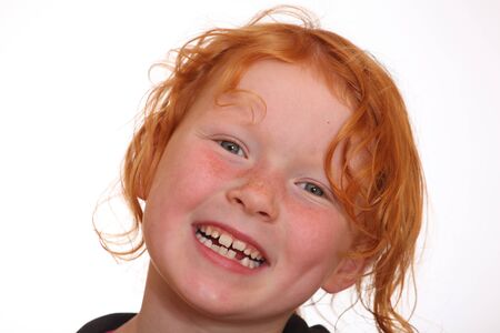 Portrait of a smiling red-haired girlの写真素材