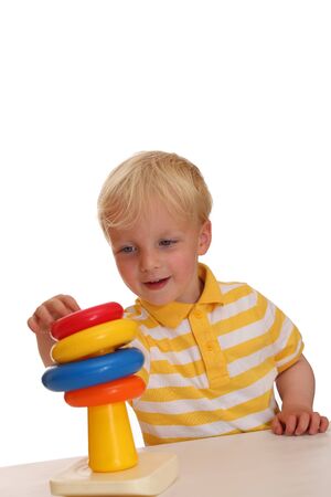 Young boy plays with his new stacking ringsの写真素材