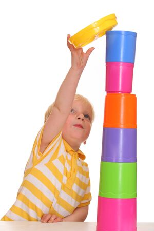 Young boy has build a funny stacking towerの写真素材