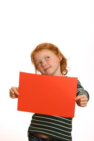Red-haired young girl holds a blank red signの写真素材