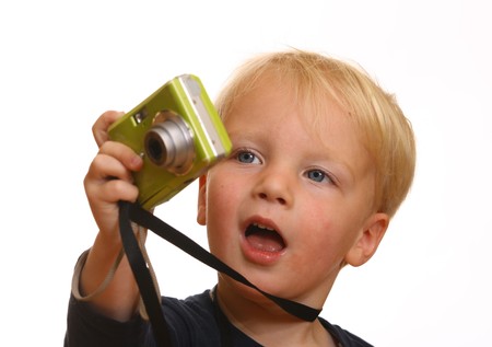 A young boy shows his new digital cameraの写真素材