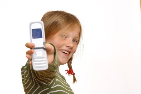 Happy young girl with plaits presents her cell phoneの写真素材