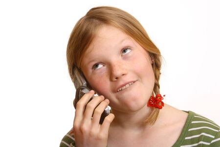 Young girl seems irritated while calling someoneの写真素材