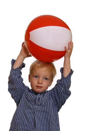 Young boy with red white stripped ballの写真素材