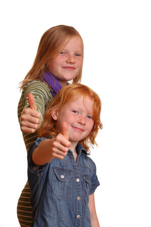 Two girls with thumbs-upの写真素材