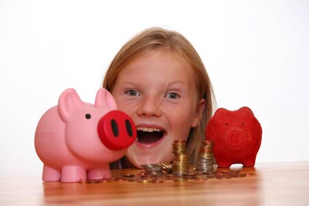 Young girl looks at her savingsの写真素材