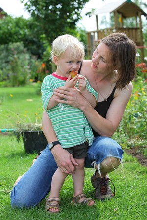 Mother and son having fun in the gardenの写真素材