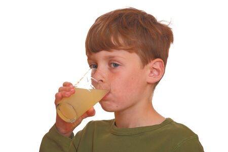 Young boy drinks juiceの写真素材