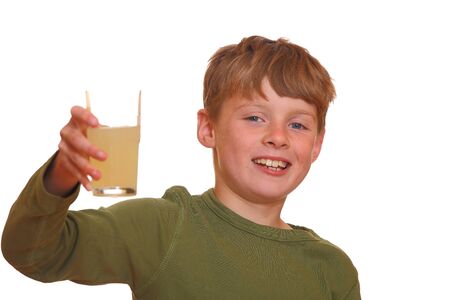 Happy young boy shows a glas full of juiceの写真素材