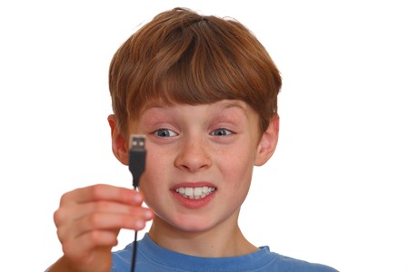 Irritated boy looks at a USB jack