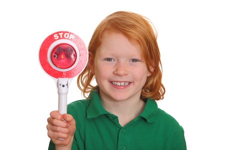 Young red haired girl shows stop sign isolated on white backgroundの写真素材
