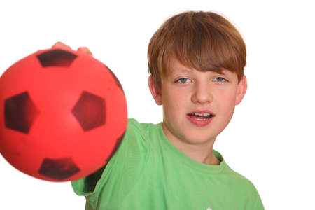 Confident teenage boy shows his soccerballの写真素材