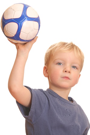 Portrait of a young boy throwing a ballの写真素材