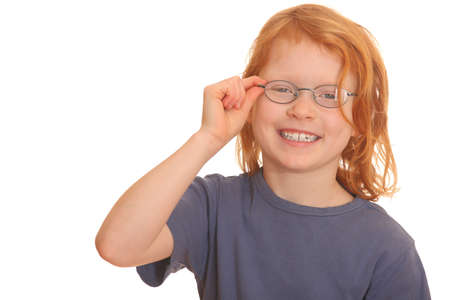 Portrait of a happy red haired girl wearing glassesの写真素材