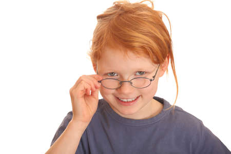 Portrait of a happy red haired girl wearing glassesの写真素材