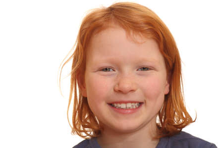 Portrait of a smiling red haired girl isolated on white background