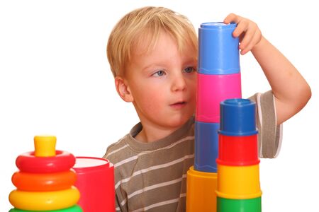 Portrait of a young boy building a toy pyramidの写真素材