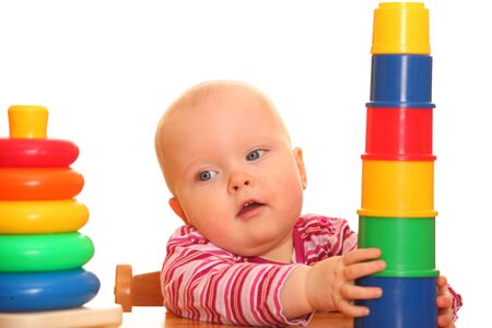 Portrait of a baby girl playing with a toy pyramidの写真素材