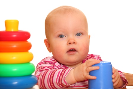 Portrait of a baby girl playing with a toy pyramidの写真素材