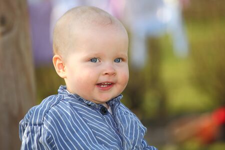 Portrait of a young toddler boy outdoorsの写真素材