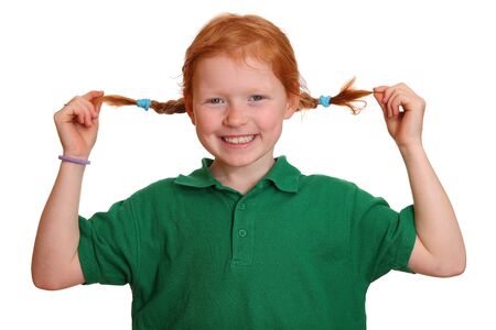 Portrait of a funny red-haired girl with braidsの写真素材