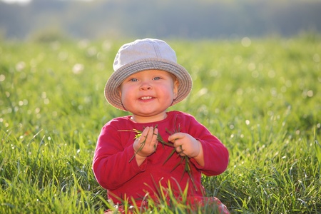 Happy young kid playing in the grass