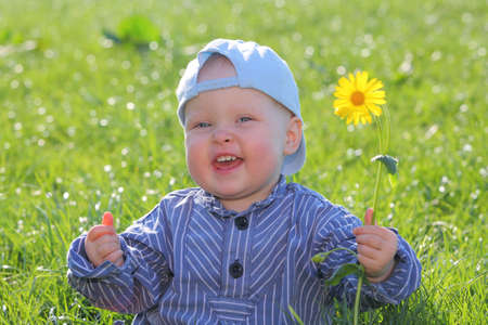 Happy young kid playing in the grass